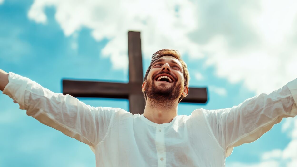Large Vecteezy A Man With His Arms Up In Front Of A Cross 57306363 Large 1248x702