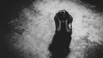 Large Vecteezy A Woman Is Standing In The Dark With Her Hands On Her Head 69962781 Large 400x225